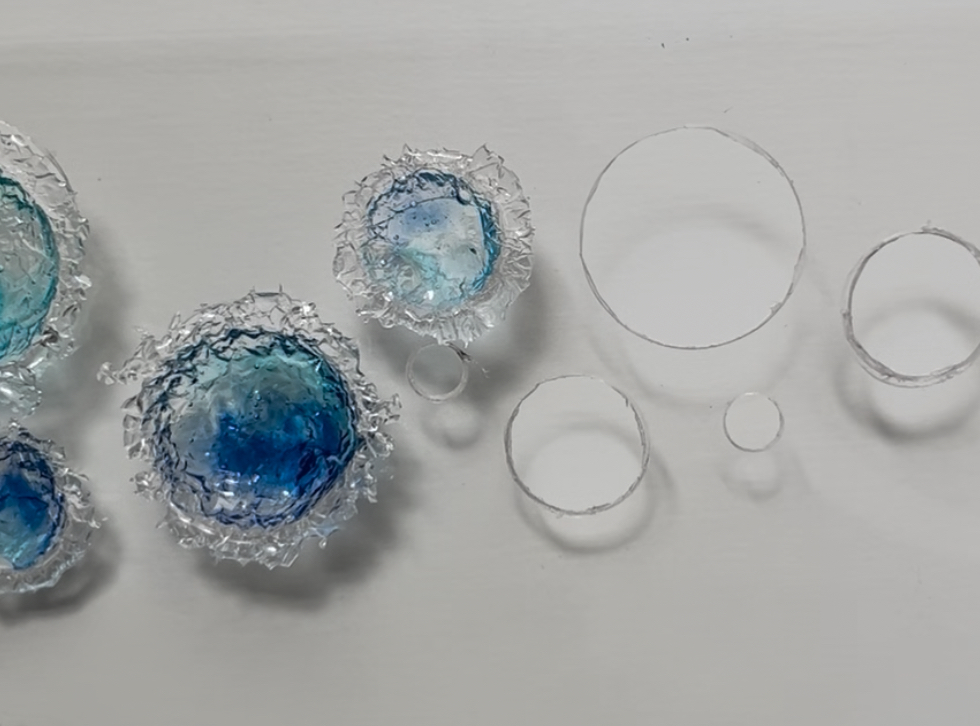 穴を開けたアクリル板の型にレジンパーツをはめ込む制作工程